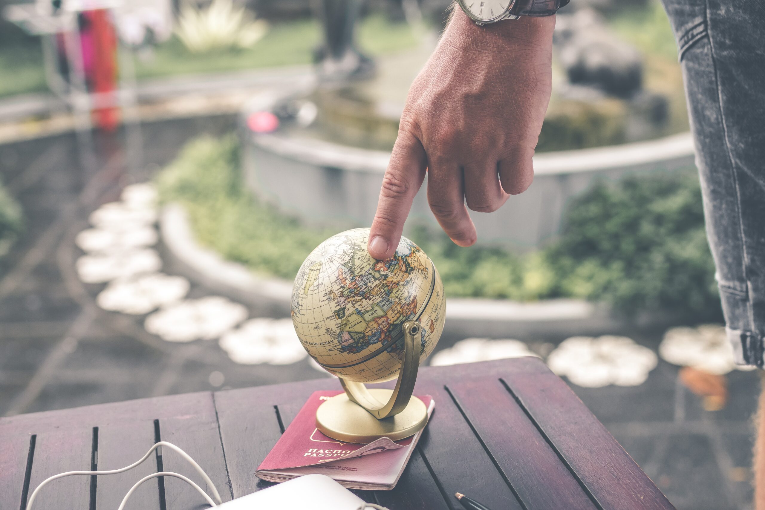 globe with finger pointing at it
