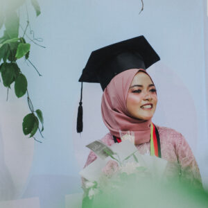 female muslim wearing traditional dress and graduation cap