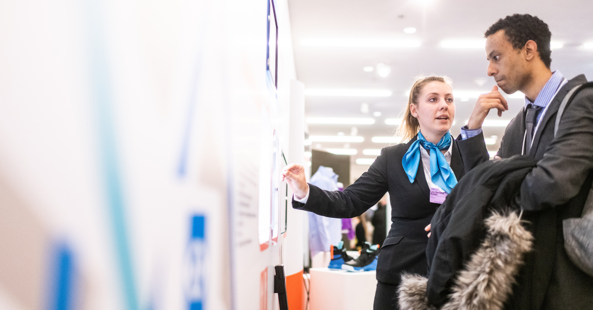 a male and female meeting at an international student recruitment fair
