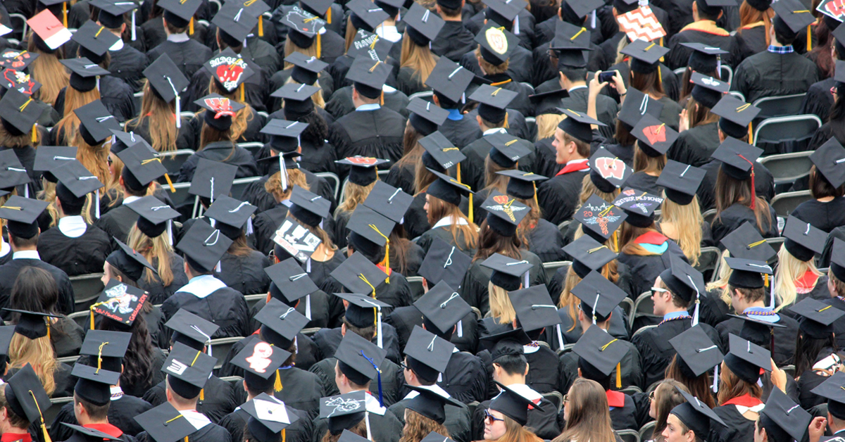 multiple international students graduating from college. Wearing graduation hats and gowns.